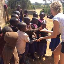 Volunteer celebrating with school children 