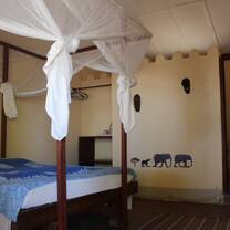 Simple and comfortable volunteer room with mosquito net in Tanzania
