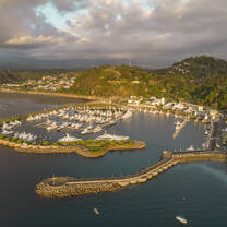 Aerial view of a marina and coastline at sunset.