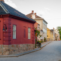 the small charming town of Fredrikstad Old Town with a red building and cobblestone street