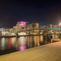 river at nighttime lit up with many lights