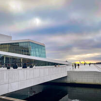the famous building Oslo Opera House shown during a pink and blue sunset