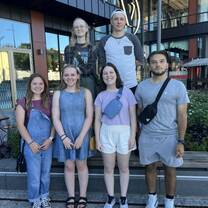 a group of college students smile together on campus in Norway