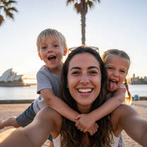 Smiling host parent with two young children outdoors in Australia