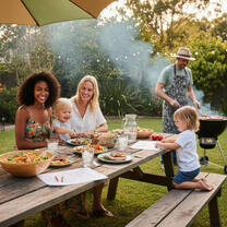 Host family and au pair sharing a relaxed outdoor meal togethe