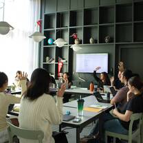 Students raising hands in class