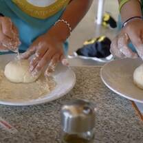Kids making pizza in Italy