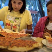 Kids eating pizza in Italy