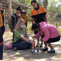 Participant running a science experiment with school children