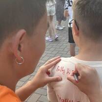 Billy signing a shirt