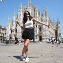 Student standing in front of the Duomo de Milán, the iconic Gothic cathedral in Milan, Italy