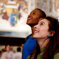 Students looking at art in the ceiling of a building