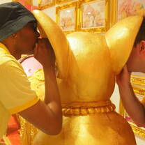 KET teachers observing local spiritual traditions at a golden shrine.