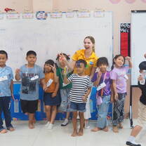 Teacher Caitlin and her students posing for a group photo after her observed teaching practicum during KETs Orientation