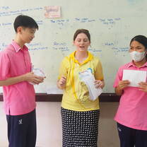 Teacher Mya engaging with Thai students during a observed teaching practicum classroom activity.