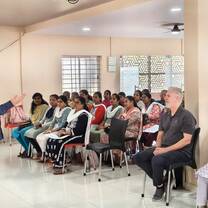 A room of students attending a course, watching the trainer. 