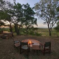 Camp fire and chairs in the bush