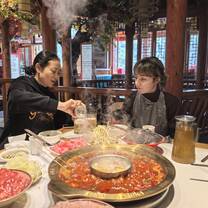 Lingoinn student tasting hotpot in Chongqing