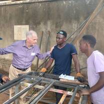 Volunteer supporting vocational training workshop at RMFSL Skilling Station in Kampala