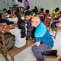 Trainer observing and supporting trainee during live classroom teaching practice.