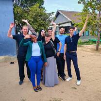 Group of TEFL trainees smiling together outdoors after completing course.