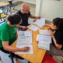 Teacher trainer reviewing written lesson plans and providing structured feedback.