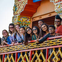 Group posing in front of a temple in Nepal.