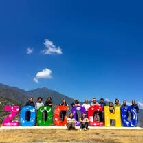 Students posing with Zoogocho sign