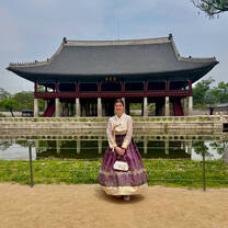 Woman in traditional Korean hanbok at Gyeonghoeru Pavilion, Gyeongbokgung Palace, Seoul.