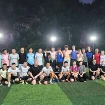 Sports college students with local football team 