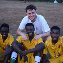 Sports coach volunteer with students 