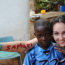 Teacher with students in Ghana