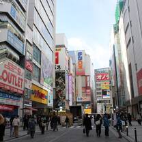 A busy street with colorful signs in the Akihabara area of Tokyo