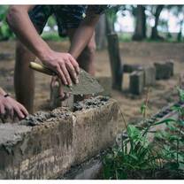 volunteers working on building a wall at a local school