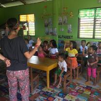 volunteer teacher in classroom with students 