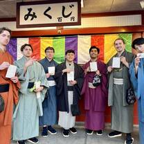 Group of students in kimonos in front of a colorful wall