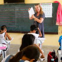 Volunteer teacher in class with students 