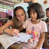 Volunteer teacher helping student 