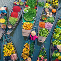 boats on water with fruits and vegetables