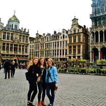 three girls standing in a courtyard