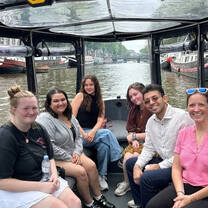 group of students on a boat on a canal