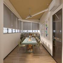 The classroom is used for both online and in-person courses and has a maximum capacity of 10 students. It includes a study library with teaching materials, a projector, a writing board, and visual learning aids displayed on the walls.