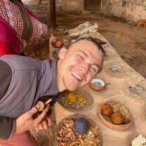 male student posing with food