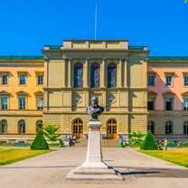 historic building with a large statue in front