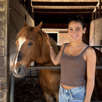 Woman volunteering at horse ranch in Barcelona