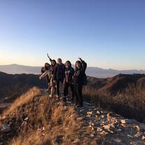 Students posing on a ridge on a hike of the Great Wall