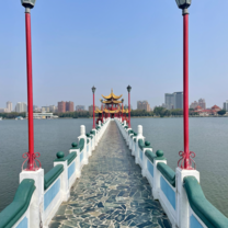 A boardwalk over the lake to a temple