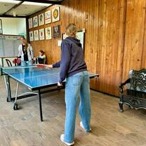 Students connecting and practicing Spanish while playing ping pong during a break at Celas Maya