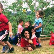 Tico Lingo volunteer playing with children in a local community project in Heredia, Costa Rica.