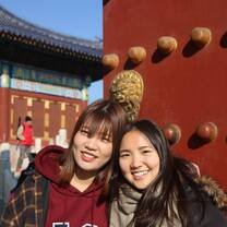 A student and roommate in front of a large door